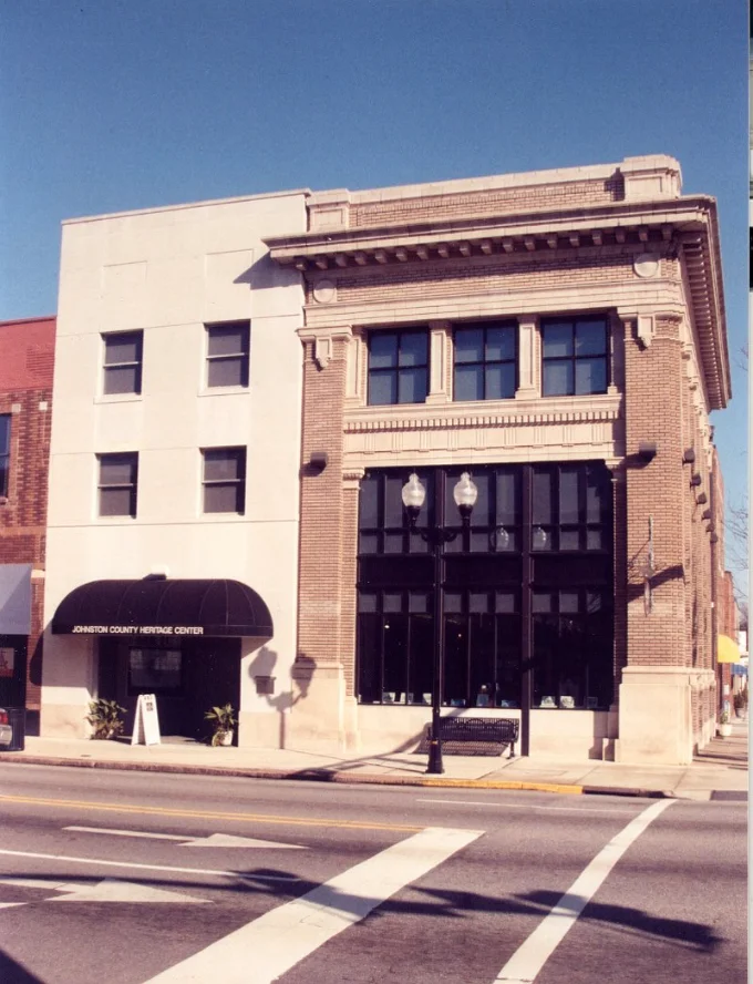 Johnston County Heritage Center Street view of the Johnston County Heritage Center, a building with a modern section and an older, ornate brick section.
