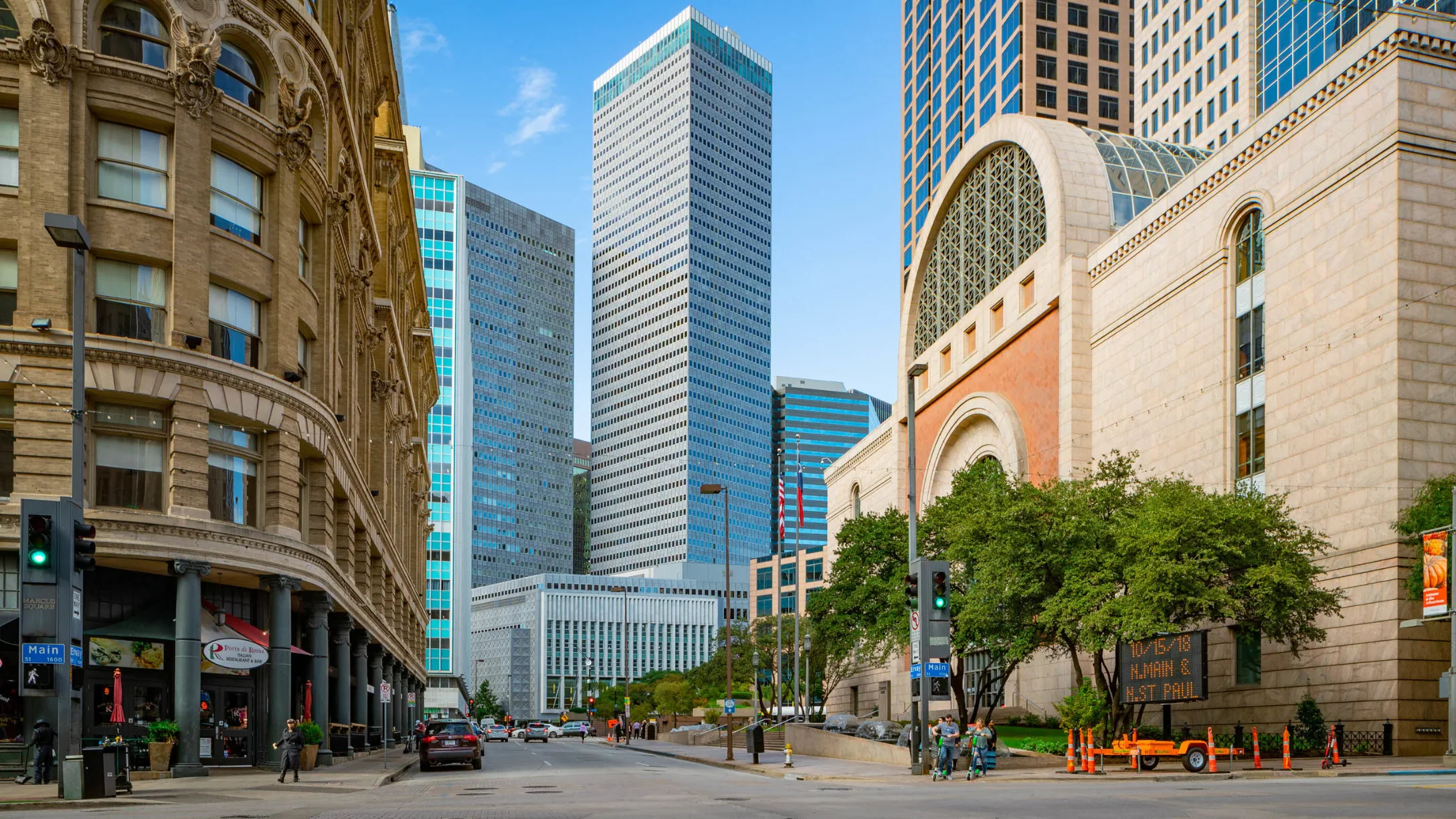 Downtown Houston Streetscape Street view of downtown Houston with modern skyscrapers, historic buildings, and traffic.